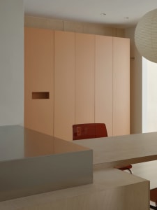 A modern office interior featuring sleek minimalist furniture, contemporary lighting, and a minimalist color palette.