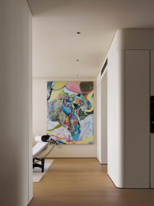 A modern living room featuring a contemporary abstract painting on the wall.