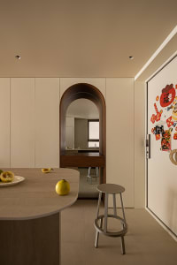A minimalist kitchen interior with neutral tones and modern design features.