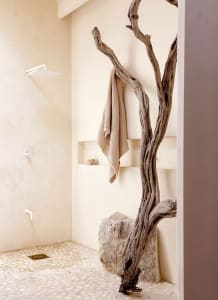 Modern minimalist bathroom with stone wall and tree branch