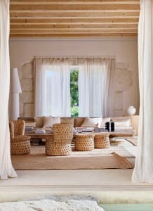 A minimalist living room featuring natural fiber furniture and neutral color palette