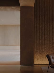 A modern living space featuring concrete walls and minimalist design.