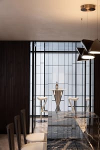 Modern interior design featuring a bar area with granite countertop and mix of materials.