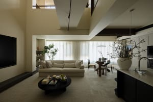 A modern minimalist living room with neutral colors and clean lines, featuring a beige sofa, a round coffee table, and a larg