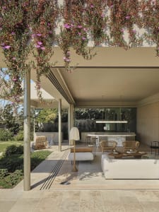 A minimalist patio with concrete, wood, and natural stone materials.