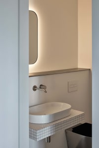 Modern bathroom featuring ceramic tiles and a minimalist design.