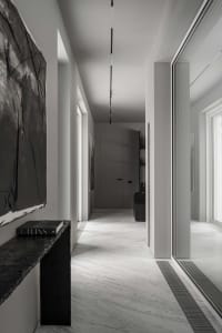 Modern white marble interior with minimalist design and black accents.