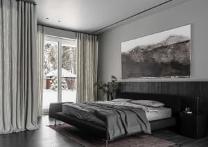 A modern, minimalist bathroom featuring a black bed and fabric textures.
