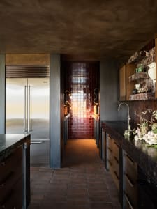 A minimalist kitchen featuring marble countertops and wooden cabinetry.