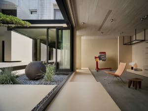 Modern living area with concrete patio, minimalist decor, and outdoor seating.