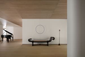 Minimalist style interior space featuring a combination of wood and metal materials and furniture.