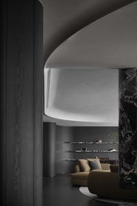 Modern minimalist living room featuring concrete and marble materials
