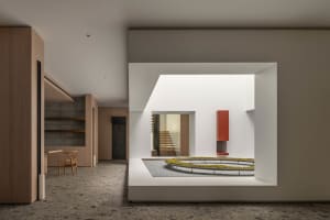 Modern entryway featuring concrete, wood, and metal elements