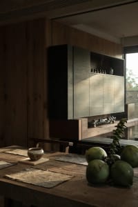 A modern kitchen with wooden cabinets and a wooden dining table.