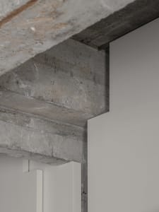 Modern minimalist interior with concrete details and clean lines.