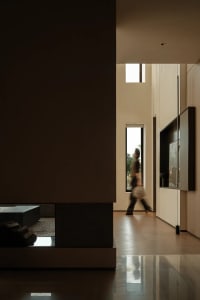 A modern living room featuring glass doors and contemporary furniture.