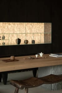 A modern living room featuring wooden furniture and shelves with decorative items.