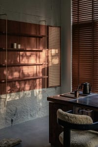 Modern study space featuring wooden shelves and a comfortable seating area.