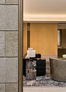 A minimalist office space featuring a concrete desk and modern design elements.