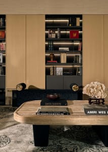 A modern interior living room with a concrete table, wooden shelves, and leather seating.
