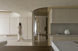 A modern, minimalist kitchen features concrete countertops and wooden cabinets, with a sleek, clean design.