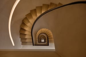A modern, spiral staircase constructed of wood.
