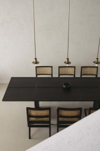 A modern dining room with a wooden table and chairs, minimalistic design and geometric shapes.