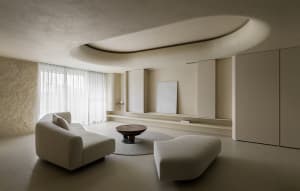 Modern living room with concrete furniture and a minimalist design style.