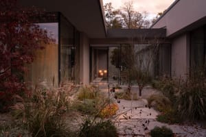 Modern residential architecture featuring concrete, glass, and stone materials.