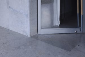 A sleek, modern interior space featuring a concrete floor and minimalist design.