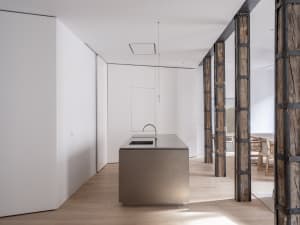 Modern kitchen interior featuring a metal countertop and minimalist design elements.