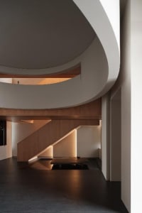 Modern architectural interior space featuring wooden and concrete materials.