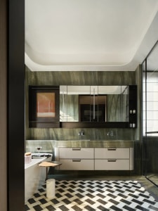 Modern luxury bathroom featuring a marble vanity, mirror cabinet, and geometric floor tiles.