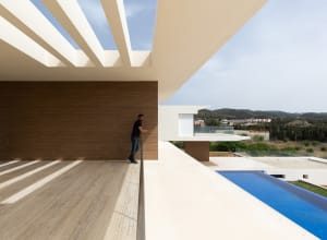 Modern residential pool deck featuring wood and concrete materials.