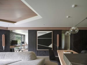 A modern living room featuring stone walls and a minimalist design.