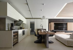 A modern residential kitchen featuring concrete and wood elements.