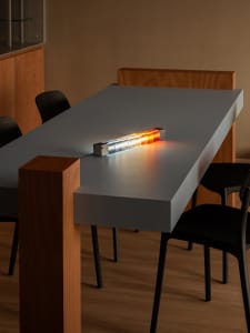 Minimalist office table with clear acrylic blocks and wooden accents, featuring LED lighting.