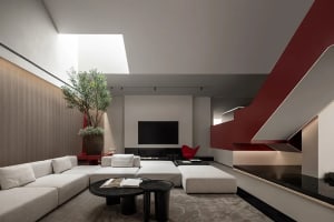 A modern living room with a concrete floor and minimalist furniture.