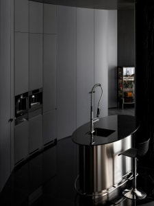 A modern kitchen featuring metal and marble finishes.