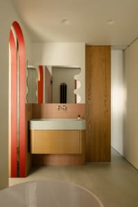 Industrial-style bathroom featuring wooden accents, ceramic tiles, and a textured meta carpet