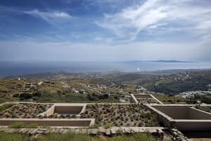 A landscape view of a coastal valley with architecture and natural elements.