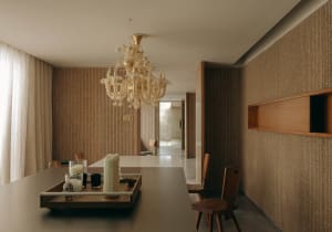 Interior design of a modern dining room featuring a wooden chandelier and furniture.