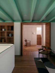A modern residential interior featuring wooden elements and a minimalist design.