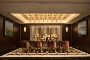 Modern restaurant interior featuring marble finishes and wooden elements.