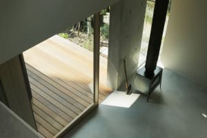 Glass wall and wooden deck with modern interior design and minimalist aesthetic, featuring wood, concrete, and metal material