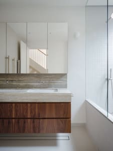 Modern bathroom featuring wooden cabinets and stone countertop