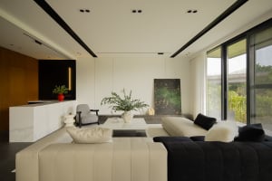 A modern living room featuring glass, marble, leather, and wool materials.