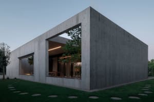 Modern, minimalist house with a concrete exterior.