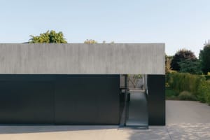 A modern residential building with a concrete and glass facade.
