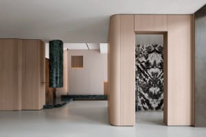 A sleek, modern office interior with metallic columns and wooden panels.